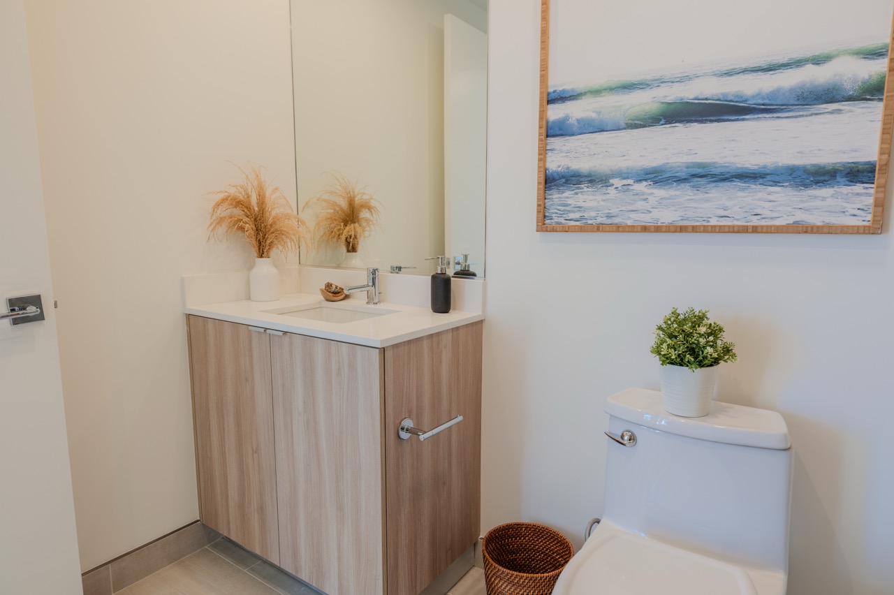 Wall-hung dark oak double vanity with a limestone countertop and wall-mounted faucets